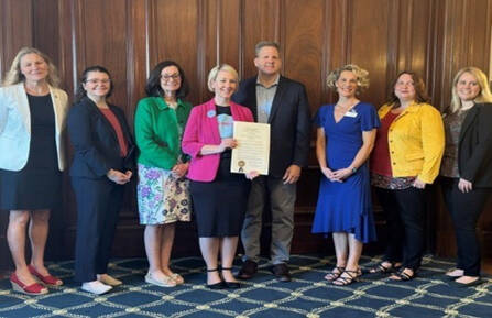 Heather A. Martin, RMA, holding the Maternal Mental Health Week proclamation, is pictured with Gov. Chris Sununu and other stakeholders.
