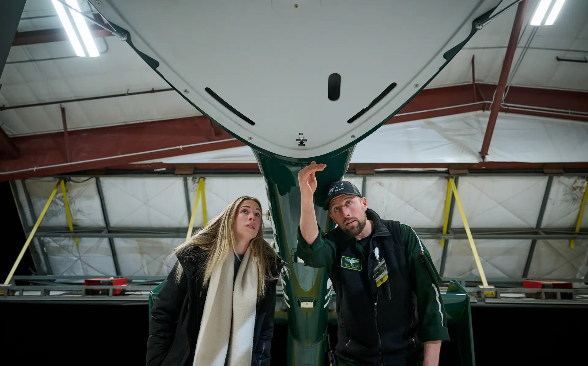 Caroline Alley and Flight Transport Nurse standing in front of DHART Helicoper