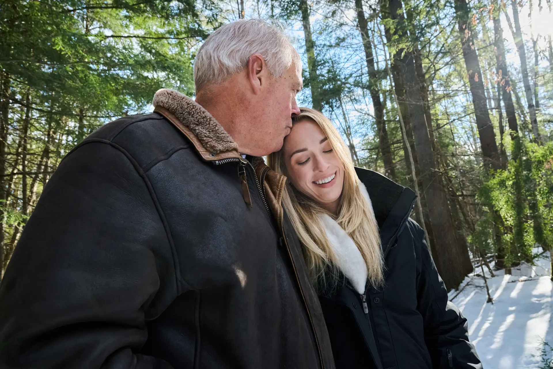Caroline Alley standing with an older gentleman in the wintry outdoors