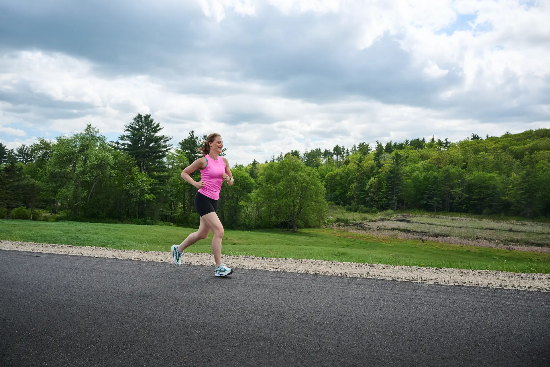 Woman runs on paved road