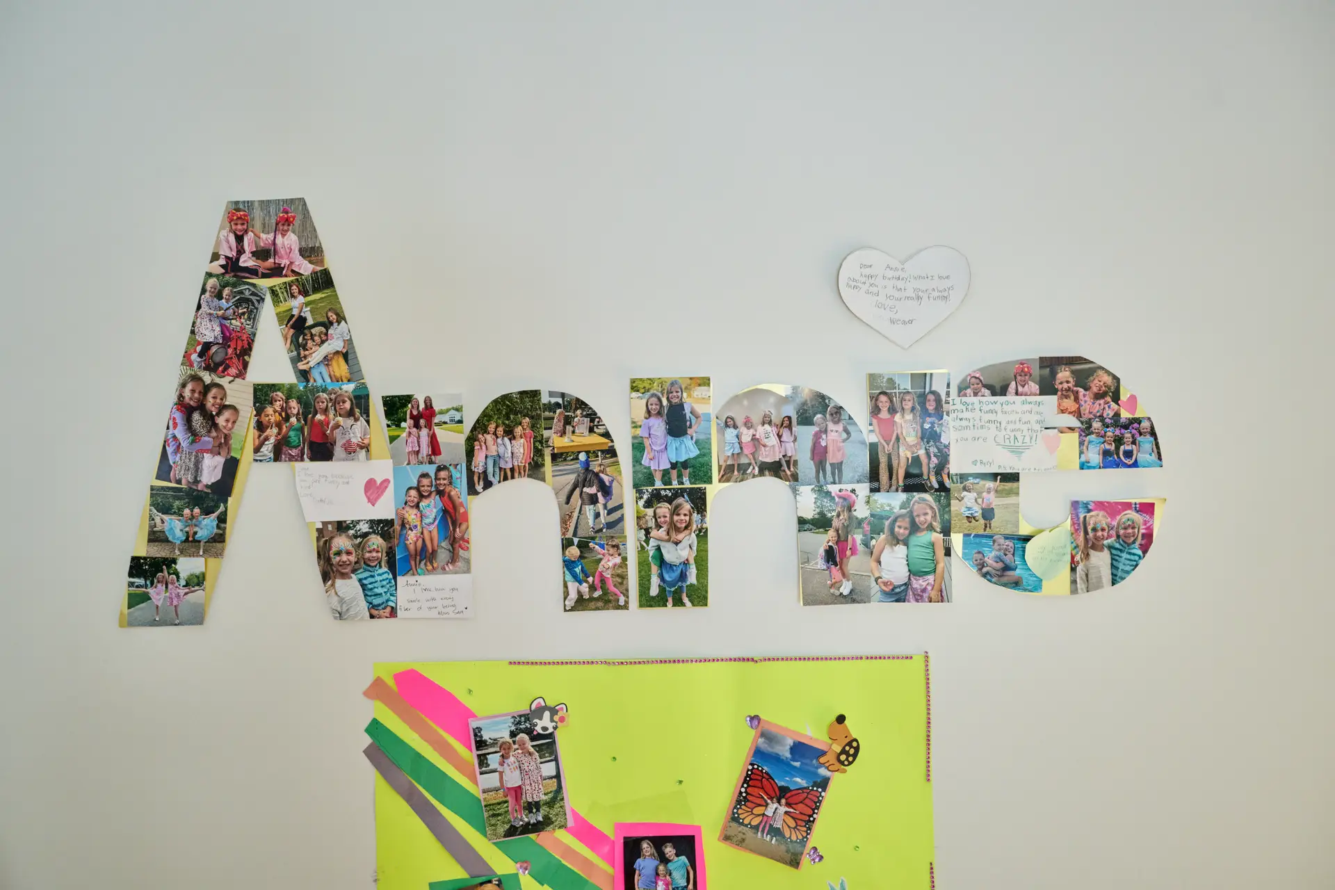 Photo collage on a wall spelling out the name Annie