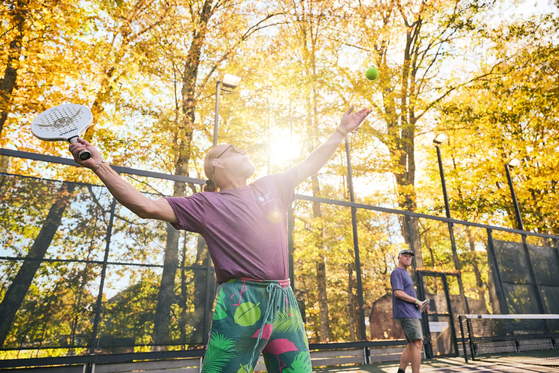 Man playing pickleball in the sun
