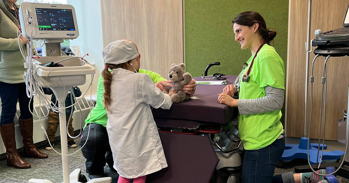 Caregivers talk with a child at the Teddy Bear Clinic