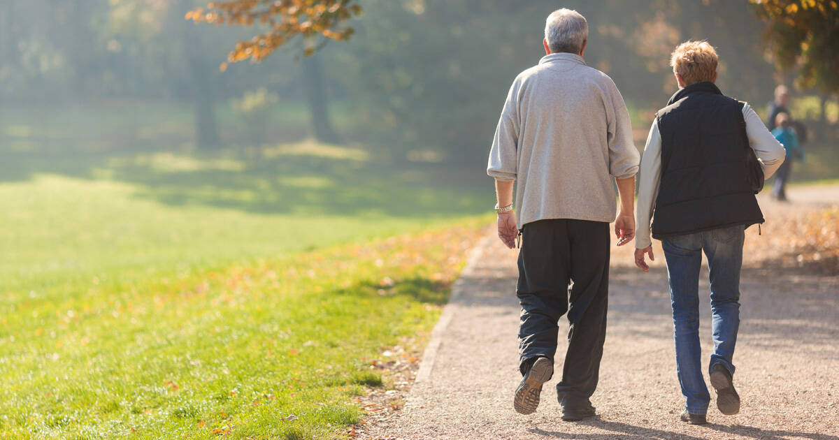 Elderly couple walking outside