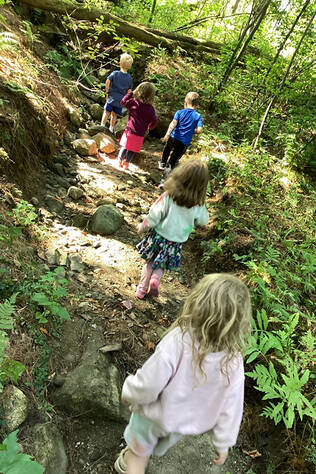 Children hiking in the woods at the Child Care Center at Dartmouth Hitchcock Medical Center