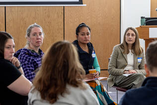 CARHE Fall Unconference participants sit in a circle inside
