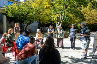 CARHE Fall Unconference participants sit in a circle outdoors