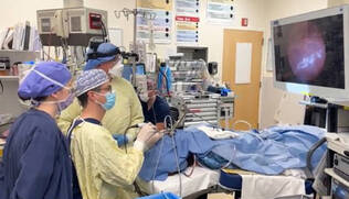 Otolaryngologists performing a procedure