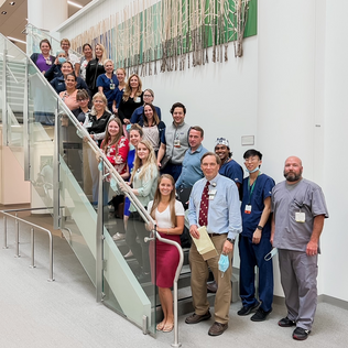 Urology team standing on staircase