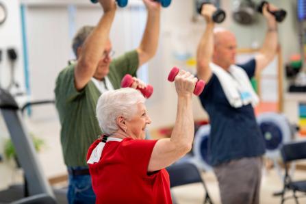 Patients working with hand weights as part of a cardiac rehabilitation class