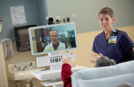 Patient participating in a telehealth visit with a nurse's assistance
