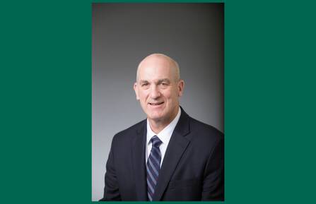 Headshot of Stephen J. LeBlanc on green background