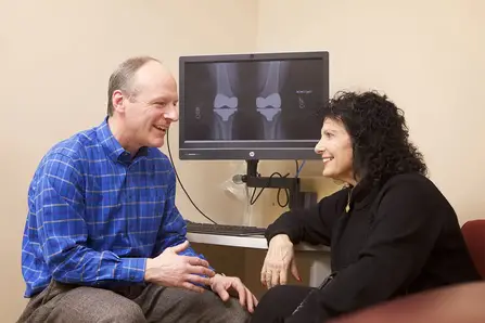 Dr. Houde talking with a patient