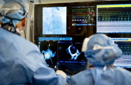 Cardiac electrophysiologists using technology during surgery