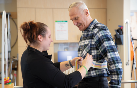 Female clinician working with an elderly male patient