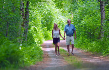 Rob and Michelle Walters walking outside holding hands