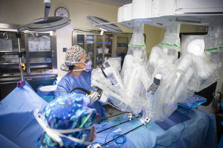 A surgeon uses a large robot to do a procedure.