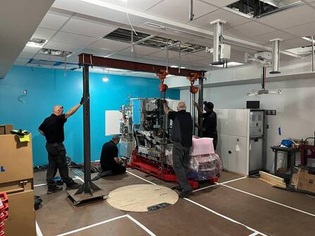 Workers install a giant machine