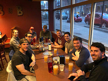 Residents enjoying pizza and beverages after a spring anatomy session with Dr. Coe.