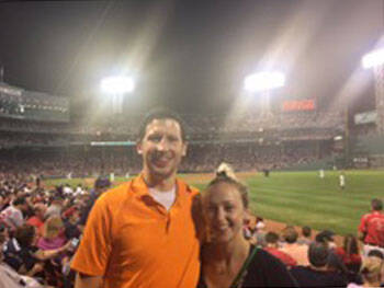 Two residents at evening baseball game.