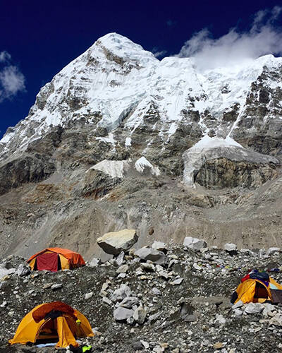 Tents camped at base of snowy mountain