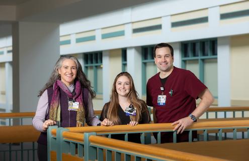 Susanne E. Tanski, MD, Jasmin J. Ward, MA II, and Daniel P. Hollander, MA II standing against a railing inside Dartmouth Hitchcock Medical Center