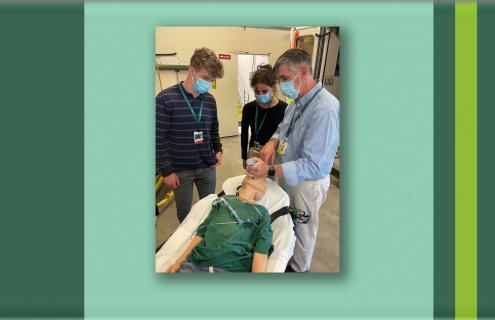 Trainees watching a teacher demonstrate endotracheal intubation a procedure on a manikin