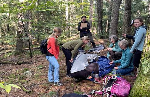 Group of women in the woods using hypowrap on an actor