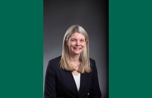 Headshot of Jennifer Gilkie on a green background