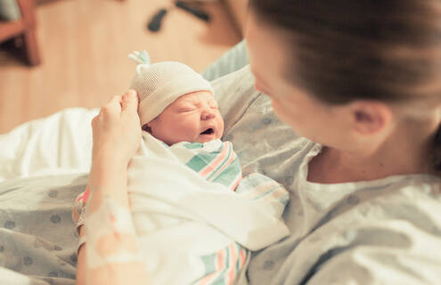 Photo of mother holding newborn baby