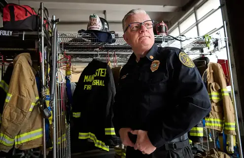 Firefighter Peter Lennon standing in the fire station