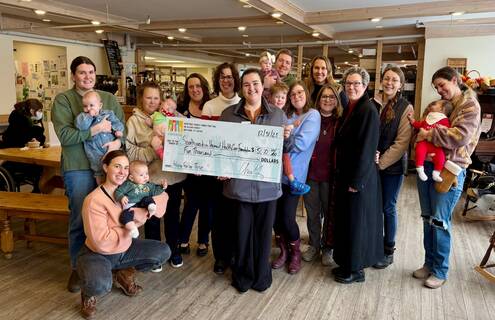 HFCU staff and Baby Café participants with donation check
