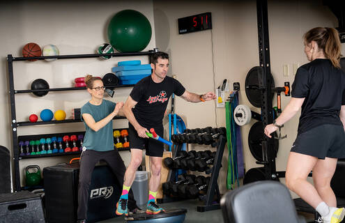 people doing balancing exercises in gym