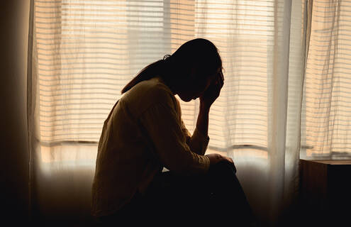 Woman in the dark with a migraine