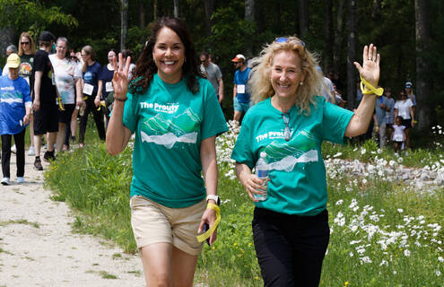 Two women lead a crowd of people at the Prouty Community Day in Manchester, NH.