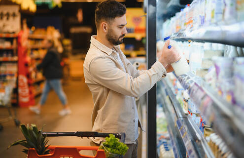 man grocery shopping for dairy products