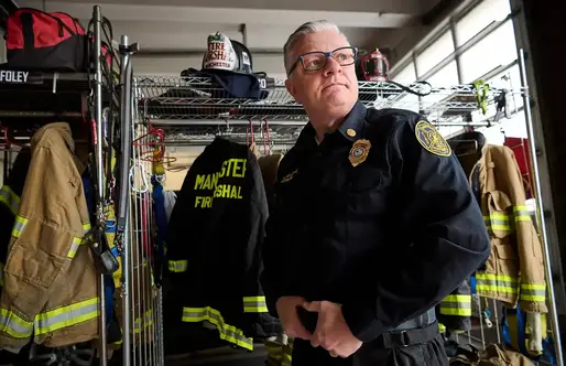Firefighter Peter Lennon standing in the fire station