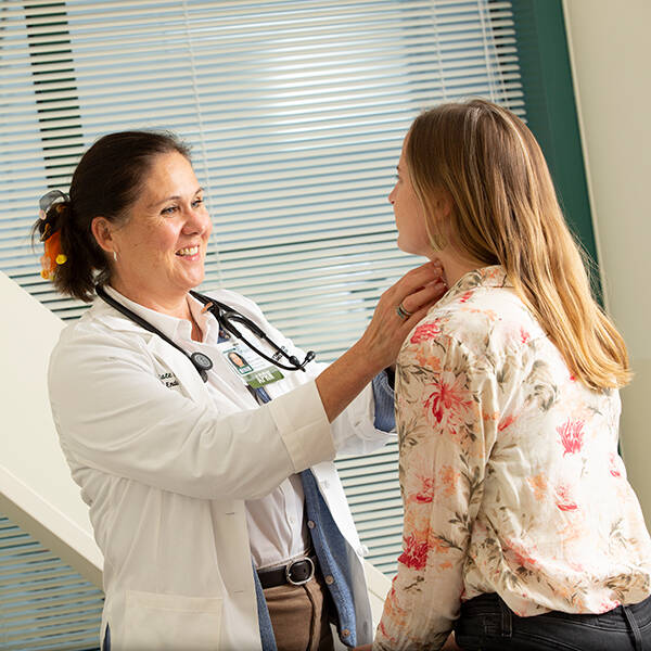 A provider examines a patient