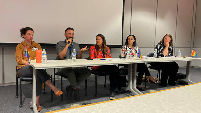 Working Toward Health Equity for the LGBTQ+ Community panelists sitting at a table