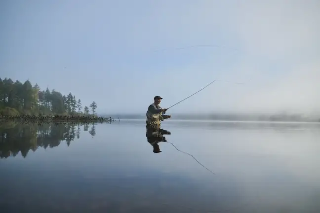 Person fly-fishing in a lake