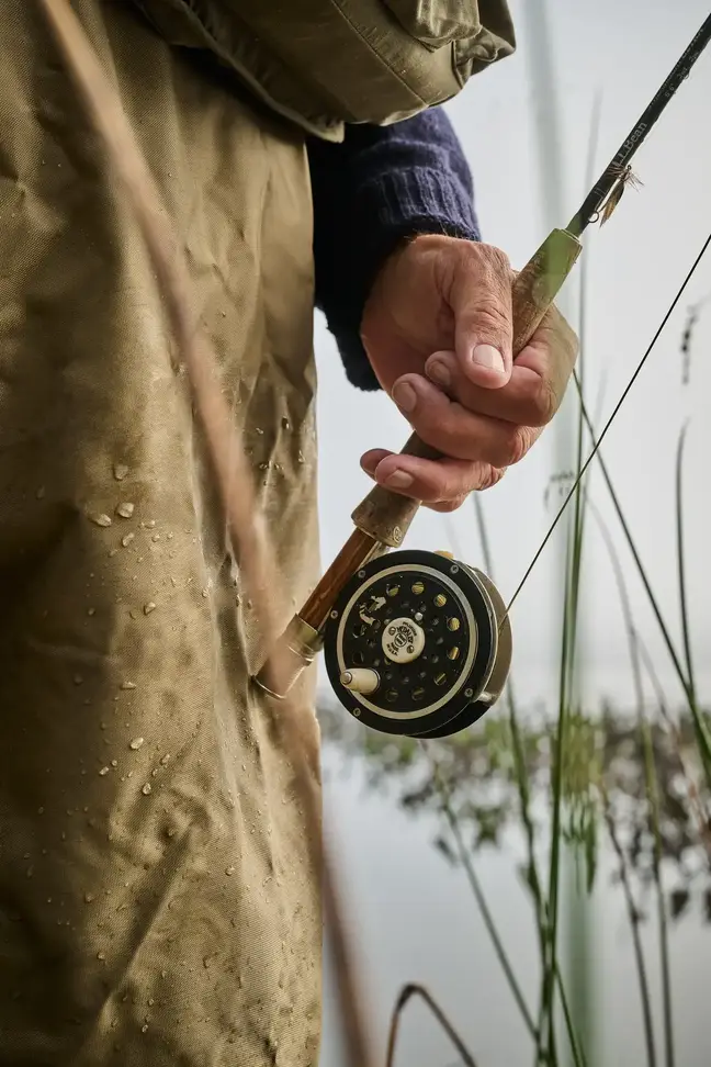 The hand of Joe Monninger holding a fly-fishing rod