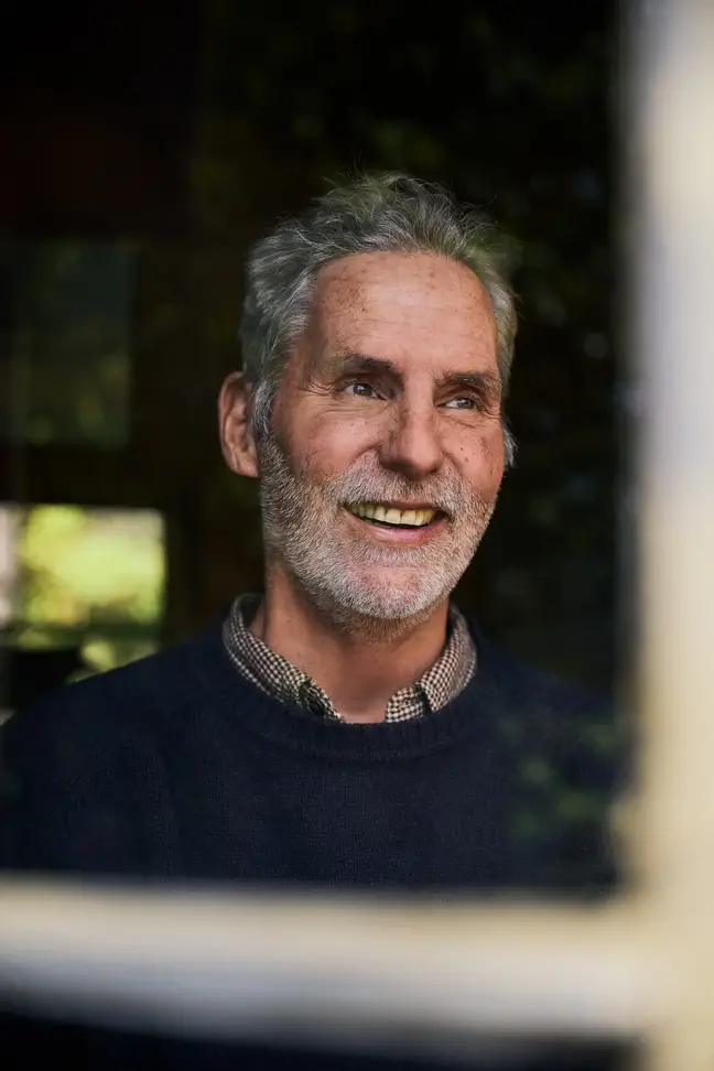 Joe Monninger seen looking out a window