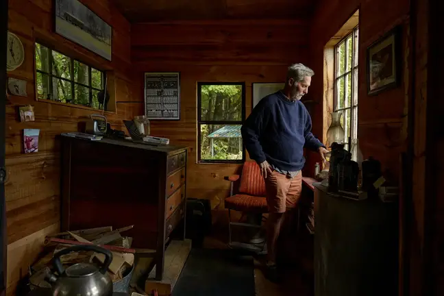 Joe Monninger stands at his study window