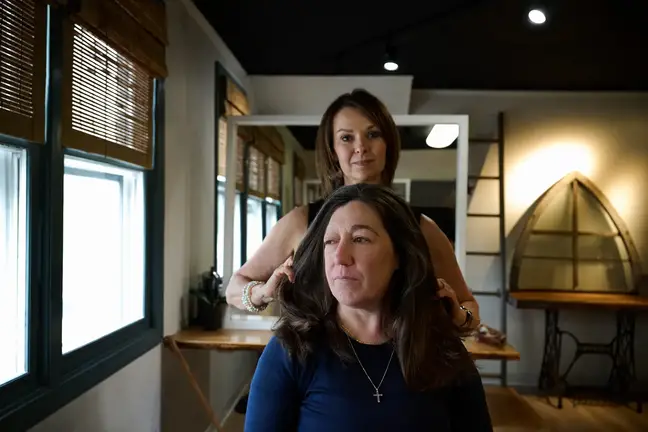 A woman receives a haircut