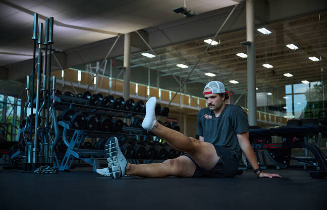 Athlete Thomas Pouliot lifting his leg