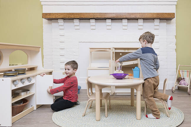 Two children play in a play kitchen at the Dartmouth Health Child Care Center at Lebanon