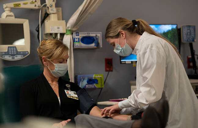 A woman taking blood
