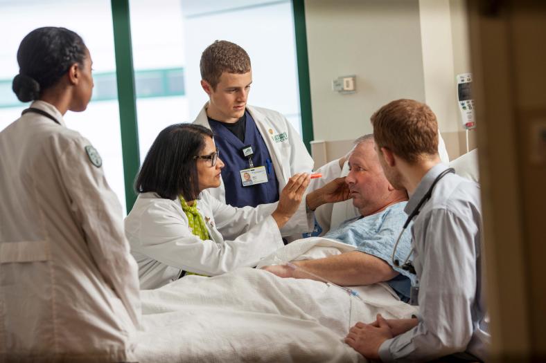A physician and medical students with a patient at Dartmouth Hitchcock Medical Center