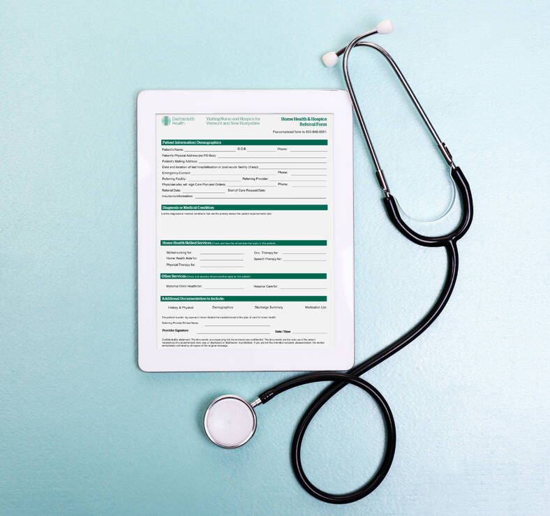 stethoscope and doctor referral form visible on electronic device