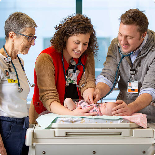 Tyler Hartman MD with baby Burke Hartman , Kathryn Richards APRN and Laura Cogswell RN in the ICN
